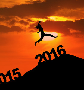 Photo of silhouette woman leaps on the hill above numbers 2016 at dusk time. New year concept